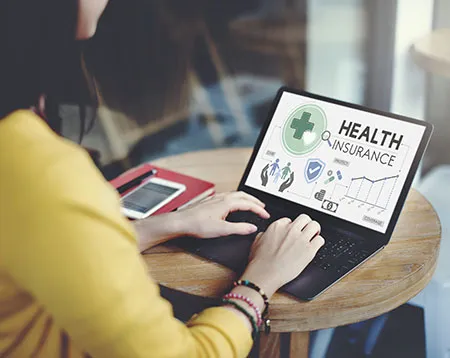 woman reviewing insurance information on a laptop