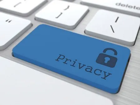 Blue key on keyboard with a lock and the word privacy